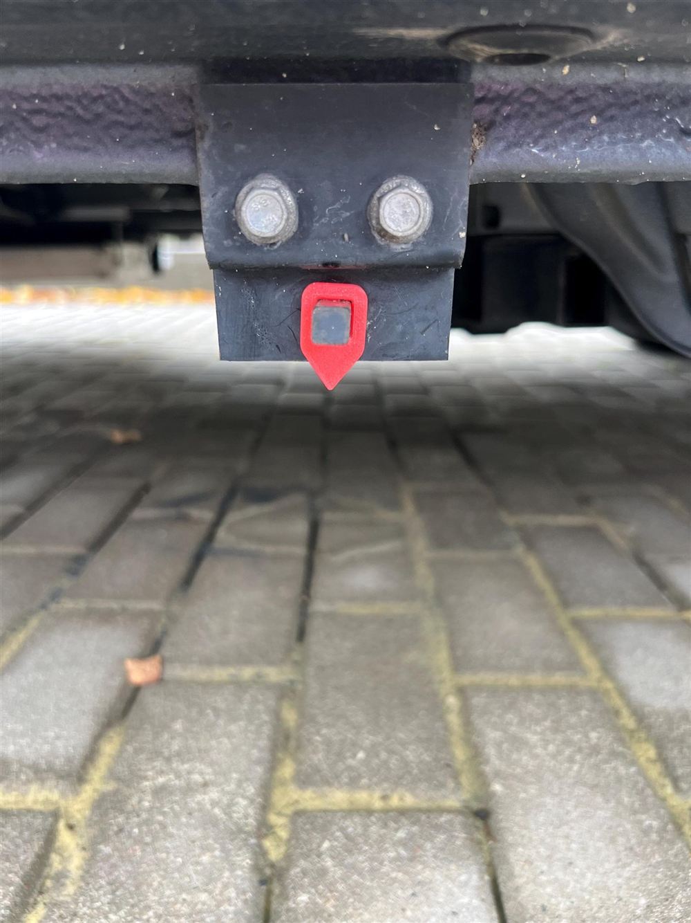 Rote Fahne am Ablassgestänge unter dem Fahrzeug